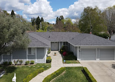 Ranch-style home with new gray architectural shingle roof, aerial drone view
