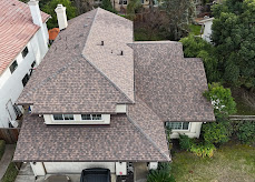 Two-story home with new tan architectural shingle roof, aerial view